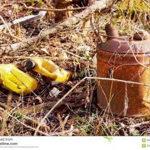 old gas can garbage overgrown vegetation 55879005