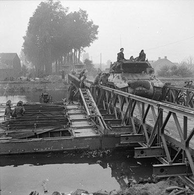 M10 tank destroyers of 77th Anti Tank Regiment 11th Armoured Division, crossing a Bailey bridge