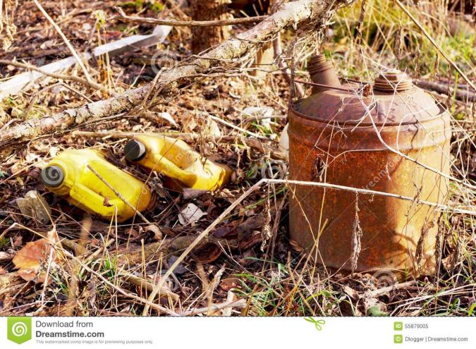 old gas can garbage overgrown vegetation 55879005